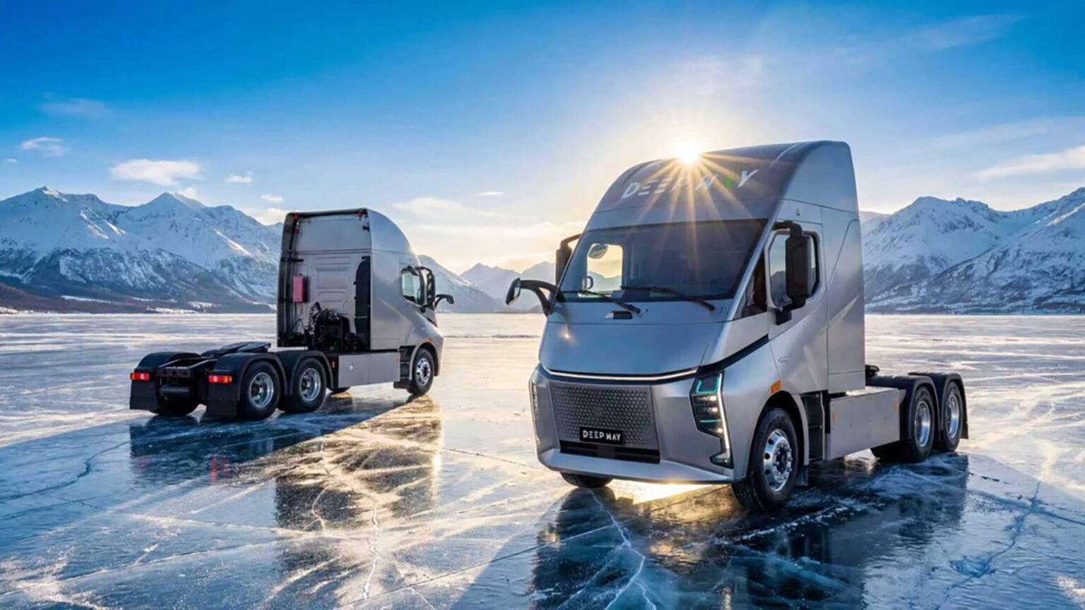 Two DeepWay electric semi-trucks parked on a frozen lake with mountain backdrop at sunrise.
