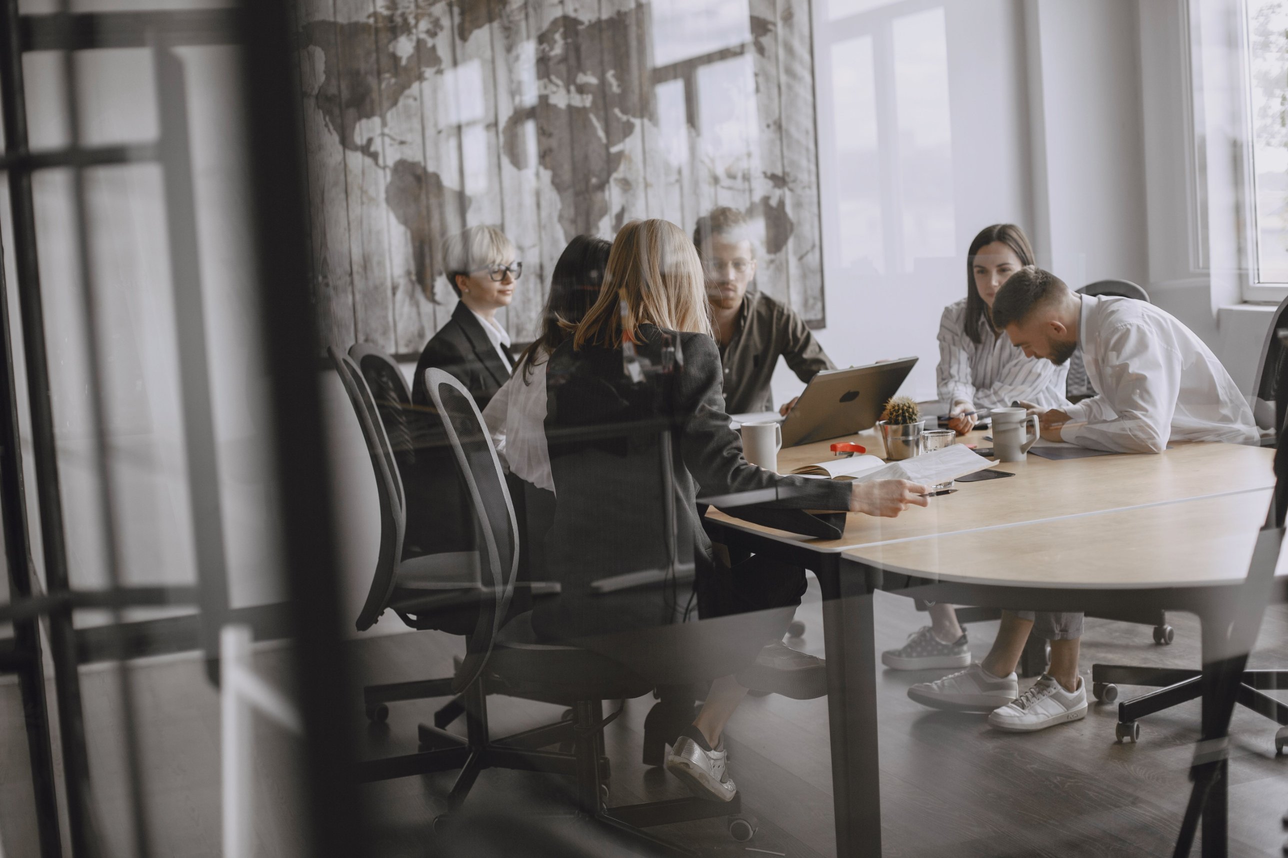 A tech industry meeting room with executives collaborating around a conference table.